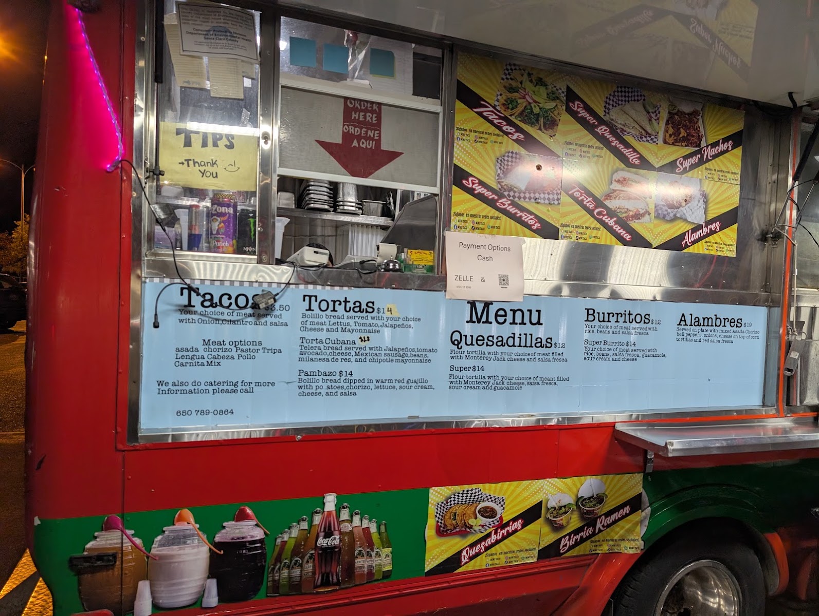 El Mini Taco street food stand at dusk with patrons enjoying tacos
