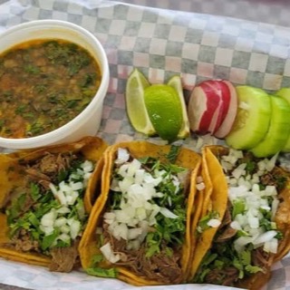 Birria tacos with consomme, lime, and radish