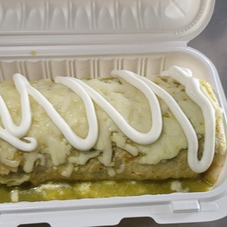 Burrito Mojado smothered in salsa verde and melted cheese
