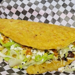 Handmade quesadilla with melted cheese and lettuce