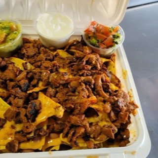 Super Nachos loaded with meat, melted cheese, guacamole, sour cream and pico de gallo